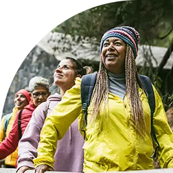 Women smiling and hiking for exercise